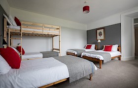 Room 1, ground floor ensuite family room with three single beds and double bunk